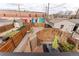 An aerial view shows a private backyard, featuring a small lawn, wooden fence and patio area with table and chairs at 3313 Curtis St, Denver, CO 80205