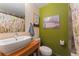 Well-lit bathroom with a modern sink, stylish mirror, and floral shower curtain at 3313 Curtis St, Denver, CO 80205