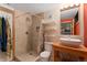 Bright bathroom featuring a tiled shower, floating shelves, and modern sink at 3313 Curtis St, Denver, CO 80205