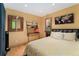 Bright bedroom featuring hardwood floors, a workstation, and a comfortable bed at 3313 Curtis St, Denver, CO 80205