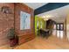 Spacious dining area with hardwood floors, exposed brick, and an adjacent staircase at 3313 Curtis St, Denver, CO 80205