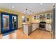Updated kitchen features stainless appliances, gas range, white cabinets, and direct access to outdoor grill at 3313 Curtis St, Denver, CO 80205