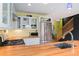 Bright kitchen featuring butcher block countertops, stainless steel appliances, and glass-front cabinets at 3313 Curtis St, Denver, CO 80205