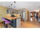 Bright kitchen boasts wood countertops, stainless appliances, white cabinets, and modern pendant lights at 3313 Curtis St, Denver, CO 80205