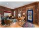 Cozy living room with exposed brick wall, hardwood floors, and ample natural light at 3313 Curtis St, Denver, CO 80205