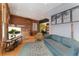 Inviting living room with exposed brick, modern decor, hardwood flooring and abundant natural light, creating a warm atmosphere at 3313 Curtis St, Denver, CO 80205