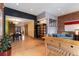 Open concept living area with hardwood floors, exposed brick accent wall, and seamless flow to the dining space at 3313 Curtis St, Denver, CO 80205