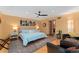 This sunny main bedroom features wood floors, sitting area and ensuite bathroom at 3313 Curtis St, Denver, CO 80205