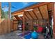 This backyard shed has a wooden roof and is setup as a workout space at 3313 Curtis St, Denver, CO 80205
