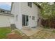Back of the house with access to the backyard, wood fence, and small patio with pavers at 13438 E 13Th Pl, Aurora, CO 80011