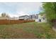 Spacious backyard with wooden fence, a lawn and view of surrounding buildings at 13438 E 13Th Pl, Aurora, CO 80011