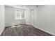 Basement showcasing a window, wood floors and an entrance to a bathroom at 13438 E 13Th Pl, Aurora, CO 80011