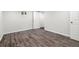 Basement area with wood flooring, showcasing doorways and ample space at 13438 E 13Th Pl, Aurora, CO 80011