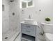 Stylish bathroom featuring a marble tiled shower, modern vanity, and white vessel sink at 13438 E 13Th Pl, Aurora, CO 80011