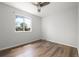 Inviting bedroom featuring hardwood floors and a large window for natural light at 13438 E 13Th Pl, Aurora, CO 80011