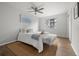 Bright bedroom featuring stylish decor, ceiling fan, and large window at 13438 E 13Th Pl, Aurora, CO 80011