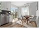 Bright dining area features modern light fixture and sliding door to yard at 13438 E 13Th Pl, Aurora, CO 80011
