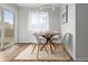 Dining area with wood table, modern light fixture, and natural light at 13438 E 13Th Pl, Aurora, CO 80011