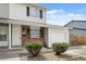 Close up of a charming exterior with brick accents and a well-kept lawn with an attached garage at 13438 E 13Th Pl, Aurora, CO 80011