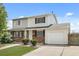 Inviting two-story exterior featuring a combination of brick and siding, plus an attached one car garage at 13438 E 13Th Pl, Aurora, CO 80011