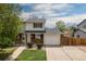 Charming two-story home with brick accents, attached garage, and well-manicured front lawn at 13438 E 13Th Pl, Aurora, CO 80011