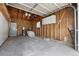 Spacious garage with exposed wood framing, overhead storage, and concrete floor at 13438 E 13Th Pl, Aurora, CO 80011