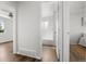 Hallway with views into bath and bedroom with modern flooring at 13438 E 13Th Pl, Aurora, CO 80011
