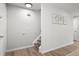 Bright hallway leading to the upper level with wood-look flooring and updated wall decor at 13438 E 13Th Pl, Aurora, CO 80011