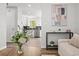 Open-concept living room showcasing the seamless flow to the modern kitchen with stainless steel appliances at 13438 E 13Th Pl, Aurora, CO 80011