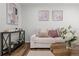 Cozy living room featuring a comfortable couch, stylish decor, and warm wood flooring at 13438 E 13Th Pl, Aurora, CO 80011