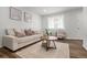 Comfortable living room featuring neutral tones, wood look flooring and an abundance of natural light at 13438 E 13Th Pl, Aurora, CO 80011
