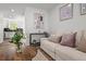 Inviting living room with a cozy couch, decorative artwork, and a glimpse into the updated kitchen at 13438 E 13Th Pl, Aurora, CO 80011