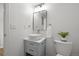 Well-lit powder room with vessel sink, blue vanity, and contemporary design at 13438 E 13Th Pl, Aurora, CO 80011