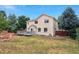 Two story home boasts a charming backyard with deck and mature trees at 3575 W Hamilton Pl, Denver, CO 80236