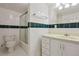 Clean bathroom featuring tiled walls, modern fixtures, and shower-tub combo at 3575 W Hamilton Pl, Denver, CO 80236