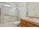 Bathroom with a shower and tub, safety grab bar, modern fixtures, and neutral finishes at 3575 W Hamilton Pl, Denver, CO 80236