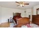 Bedroom with wood flooring, a ceiling fan, and a traditional style bed and furnishings at 3575 W Hamilton Pl, Denver, CO 80236
