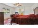 Bedroom with a large window bringing in natural light, showcasing a comfy bed and an open en suite bathroom at 3575 W Hamilton Pl, Denver, CO 80236