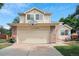 Charming two-story home featuring a two-car garage with a basketball hoop, and manicured landscaping at 3575 W Hamilton Pl, Denver, CO 80236