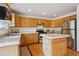 Well-lit kitchen featuring stainless steel appliances, an island, and plenty of counter space at 3575 W Hamilton Pl, Denver, CO 80236