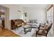 Cozy living room featuring a vintage piano, comfortable seating, and bright natural light at 3575 W Hamilton Pl, Denver, CO 80236