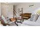 Inviting living room area with a staircase and vintage piano leading to additional rooms at 3575 W Hamilton Pl, Denver, CO 80236