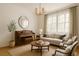 Bright living room with neutral tones, a piano, and natural light streaming through large windows at 3575 W Hamilton Pl, Denver, CO 80236