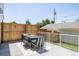 Outdoor patio space features a dining table, chairs, and privacy fence for outdoor entertainment at 4131 Quivas St, Denver, CO 80211