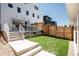 Spacious backyard with patio, lawn, and modern white home at 4131 Quivas St, Denver, CO 80211