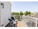 A cozy balcony featuring a white railing and comfortable chairs with green cushions, perfect for outdoor relaxation at 4131 Quivas St, Denver, CO 80211