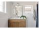 Bright bathroom featuring wood vanity, chrome fixtures, white quartz countertop and subway tile at 4131 Quivas St, Denver, CO 80211