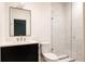 A modern bathroom features a sleek vanity, glass-enclosed shower, and contemporary finishes at 4131 Quivas St, Denver, CO 80211