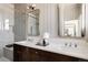 Modern bathroom featuring double sinks, a marble countertop, and a glass-enclosed shower at 4131 Quivas St, Denver, CO 80211