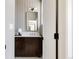 Charming bathroom with updated vanity, decorative mirror and modern light fixture at 4131 Quivas St, Denver, CO 80211
